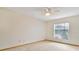Bedroom featuring neutral carpet, ceiling fan and a large window providing ample natural light at 2806 Forest Club Dr, Plant City, FL 33566