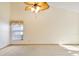 Bright bedroom featuring neutral carpet, vaulted ceilings, fan, and a large window for natural light at 2806 Forest Club Dr, Plant City, FL 33566