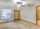Bedroom featuring neutral carpet, ceiling fan and closet with bi-fold doors for optimal storage at 2806 Forest Club Dr, Plant City, FL 33566