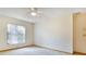 Bedroom featuring neutral carpet, ceiling fan and a large window providing ample natural light at 2806 Forest Club Dr, Plant City, FL 33566