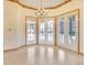 Dining area features tile flooring with light wood trim around the multiple french doors to the lanai and pool at 2806 Forest Club Dr, Plant City, FL 33566