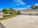 A three-car garage home features a concrete driveway and front lawn with landscaping at 2806 Forest Club Dr, Plant City, FL 33566