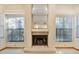 Living room fireplace with a mirror and views to the back yard through the windows at 2806 Forest Club Dr, Plant City, FL 33566
