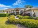 Charming home with a manicured lawn and mature landscaping at 2806 Forest Club Dr, Plant City, FL 33566