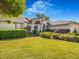 This home has manicured hedges and landscaping that complements the home's facade at 2806 Forest Club Dr, Plant City, FL 33566
