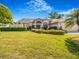 A well-manicured front lawn and hedge landscaping highlight this home's facade at 2806 Forest Club Dr, Plant City, FL 33566