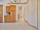 Bright hallway view with decorative trim, tile flooring, and view of kitchen area and beyond at 2806 Forest Club Dr, Plant City, FL 33566