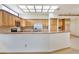 Charming kitchen featuring stainless steel appliances, light wood cabinetry, and a bright skylight at 2806 Forest Club Dr, Plant City, FL 33566