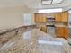 Modern kitchen showcasing granite countertops, wooden cabinets, and stainless steel appliances at 2806 Forest Club Dr, Plant City, FL 33566