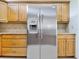 Updated kitchen with a stainless steel refrigerator and light wood cabinetry at 2806 Forest Club Dr, Plant City, FL 33566