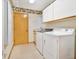 Bright laundry room with modern washer and dryer, shelving, and convenient utility sink at 2806 Forest Club Dr, Plant City, FL 33566