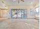 Open living room with access to the screened lanai and pool at 2806 Forest Club Dr, Plant City, FL 33566