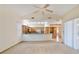 Spacious living room with a view of the kitchen and a high ceiling with fan at 2806 Forest Club Dr, Plant City, FL 33566