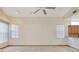Bright living room with neutral walls and flooring, featuring two large windows and kitchen views at 2806 Forest Club Dr, Plant City, FL 33566