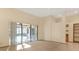 Spacious living room featuring sliding doors to the lanai, tile and carpet flooring, and custom built-in shelving at 2806 Forest Club Dr, Plant City, FL 33566