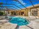 A screened-in pool and spa feature concrete pavers and exterior access to the home at 2806 Forest Club Dr, Plant City, FL 33566