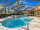 An outdoor screened-in pool and spa area are surrounded by lush, mature landscaping at 2806 Forest Club Dr, Plant City, FL 33566