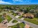 A neighborhood street featuring well-maintained homes with landscaped yards, driveways, and clear blue skies at 2806 Forest Club Dr, Plant City, FL 33566