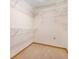 Spacious walk-in closet with carpeted floor and multiple built-in metal shelving units for optimal storage at 2806 Forest Club Dr, Plant City, FL 33566