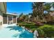 Green backyard with a blue tile patio and a privacy fence in the background at 2991 Covewood Pl, Clearwater, FL 33761