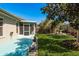 Manicured backyard showcasing landscaping, privacy fence, and screened lanai at 2991 Covewood Pl, Clearwater, FL 33761