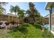 Landscaped backyard with garden, mature trees and privacy fence at 2991 Covewood Pl, Clearwater, FL 33761
