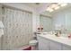 Bright bathroom with a floral shower curtain, a well-lit mirror, and a spacious vanity at 2991 Covewood Pl, Clearwater, FL 33761