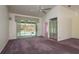 Bright bedroom with screened patio access and vaulted ceiling at 2991 Covewood Pl, Clearwater, FL 33761