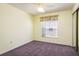 Cozy bedroom with a window, ceiling fan, and carpet flooring at 2991 Covewood Pl, Clearwater, FL 33761