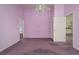 Empty bedroom featuring purple walls, carpet, and ceiling fan with light fixture at 2991 Covewood Pl, Clearwater, FL 33761