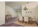 Open-concept dining area featuring a chandelier, neutral decor, and views of living area at 2991 Covewood Pl, Clearwater, FL 33761