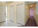 Bright hallway features tile flooring, closet doors, and access to other rooms at 2991 Covewood Pl, Clearwater, FL 33761