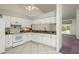Well-lit kitchen featuring white cabinets, tiled floors and stainless steel appliances at 2991 Covewood Pl, Clearwater, FL 33761