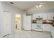 Bright kitchen features white cabinetry, tile floors, and a modern refrigerator at 2991 Covewood Pl, Clearwater, FL 33761