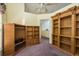 A versatile living area with built-in wooden shelving and a ceiling fan at 2991 Covewood Pl, Clearwater, FL 33761