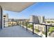 This balcony features a sleek railing and expansive views of the surrounding city and foliage at 301 1St S St # 1206, St Petersburg, FL 33701