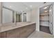 Modern bathroom featuring double sinks, wood cabinets, and a large mirror with bright lighting at 301 1St S St # 1206, St Petersburg, FL 33701