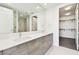 Bathroom featuring double sinks, modern vanity, and a view into the shower and closet at 301 1St S St # 1206, St Petersburg, FL 33701