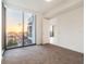 This modern bedroom boasts stunning sunset views, neutral carpet, and a bright, airy feel at 301 1St S St # 1206, St Petersburg, FL 33701