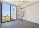 Modern bedroom with expansive city views from a large window and neutral walls at 301 1St S St # 1206, St Petersburg, FL 33701