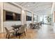 Common area with dining tables, chairs, and large-screen TVs, providing a comfortable place to relax and socialize at 301 1St S St # 1206, St Petersburg, FL 33701