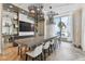 Elegant dining room with modern lighting, stylish bar stools, and a stunning ocean view at 301 1St S St # 1206, St Petersburg, FL 33701