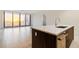 Stunning kitchen island with quartz countertop, stainless steel faucet and hardware with a living room in the background at 301 1St S St # 1206, St Petersburg, FL 33701