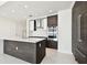 Bright modern kitchen showcasing custom cabinets, stainless steel appliances, and a center island with a quartz countertop at 301 1St S St # 1206, St Petersburg, FL 33701