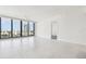 Bright living room with tile floors, ceiling fan, and a large window showcasing city views at 301 1St S St # 1206, St Petersburg, FL 33701