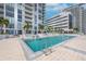 A stunning pool area is surrounded by a sleek, modern building and lush greenery at 301 1St S St # 1206, St Petersburg, FL 33701