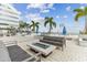 Contemporary condominium rooftop deck with a modern fire pit table and comfortable outdoor seating at 301 1St S St # 1206, St Petersburg, FL 33701