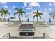 Stylish condominium rooftop deck with modern furniture and tropical palm trees at 301 1St S St # 1206, St Petersburg, FL 33701