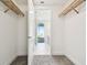 Open walk-in closet featuring custom wood shelving with a view into a modern bathroom at 301 1St S St # 1206, St Petersburg, FL 33701
