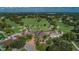 Stunning aerial view of community clubhouse, golf course, and lush landscaping on a bright, sunny day at 3021 Countryside Blvd # 26A, Clearwater, FL 33761